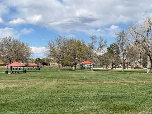 view of property's community with a playground, a gazebo, and a yard