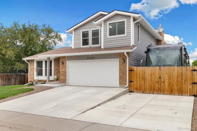 11131 Seton Pl, Westminster, CO 80031 - view of front of property featuring brick siding, driveway, and a garage