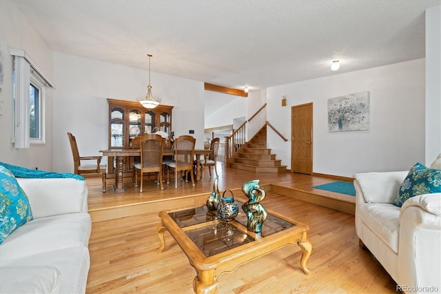 11131 Seton Pl, Westminster, CO 80031 - living area featuring stairs, light wood-style floors, and vaulted ceiling