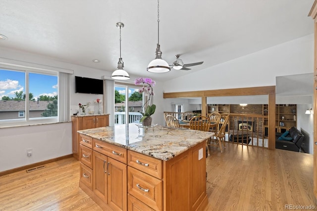 11131 Seton Pl, Westminster, CO 80031 - kitchen featuring a ceiling fan, light wood-type flooring, decorative light fixtures, light stone countertops, and baseboards