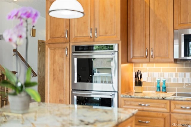 11131 Seton Pl, Westminster, CO 80031 - kitchen featuring stainless steel appliances, tasteful backsplash, and light stone countertops