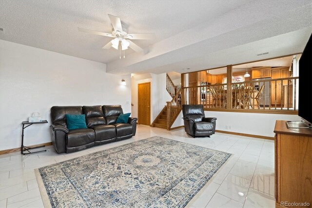 11131 Seton Pl, Westminster, CO 80031 - living room featuring stairs, ceiling fan, a textured ceiling, and baseboards