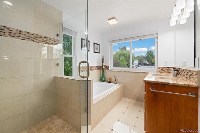 11131 Seton Pl, Westminster, CO 80031 - full bathroom featuring a shower stall, vanity, a garden tub, and tile patterned floors