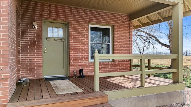 entrance to property featuring brick siding