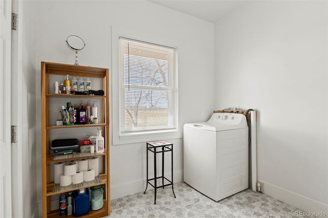 laundry area with baseboards, washer / clothes dryer, and laundry area