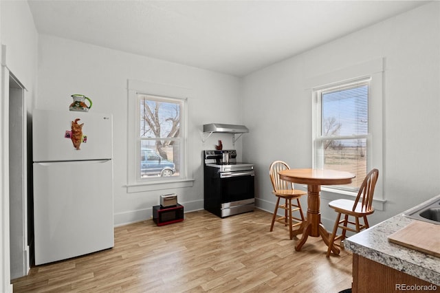 dining area with baseboards and light wood-type flooring