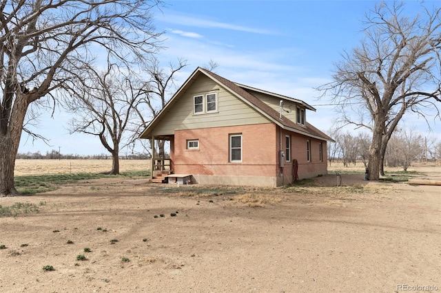view of side of home with brick siding