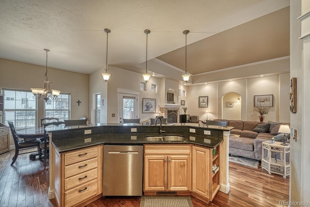 kitchen featuring stainless steel dishwasher, dark hardwood / wood-style flooring, sink, and a kitchen island with sink