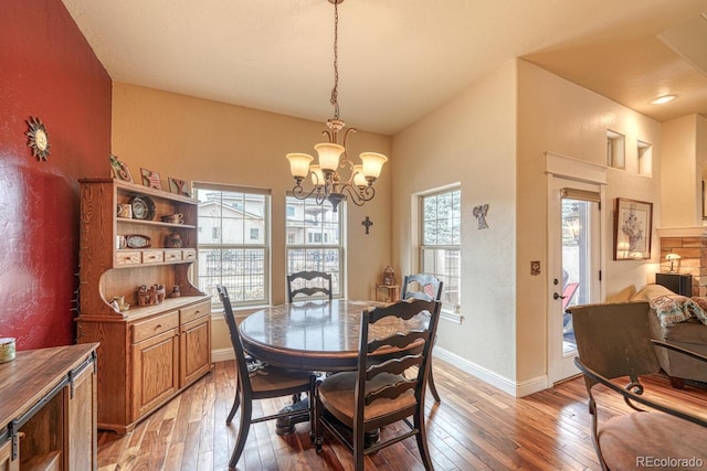 dining room with wood-type flooring and a notable chandelier