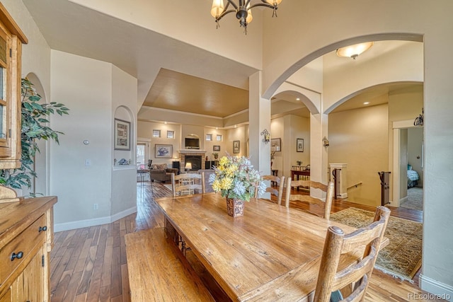 dining area with hardwood / wood-style flooring and a chandelier