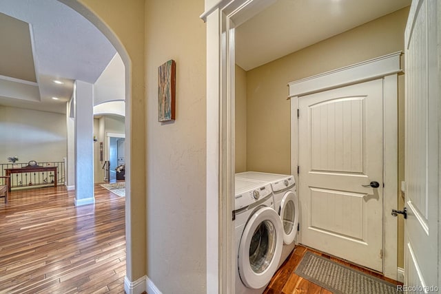 laundry area featuring washer and clothes dryer and wood-type flooring