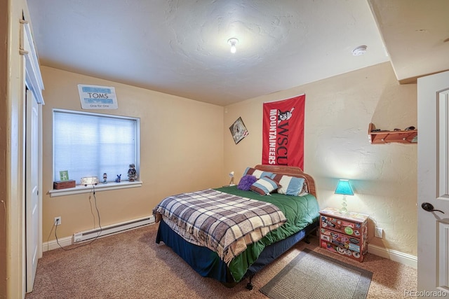 carpeted bedroom featuring baseboard heating