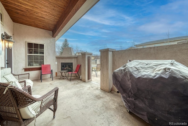 view of patio / terrace with a grill and an outdoor fireplace