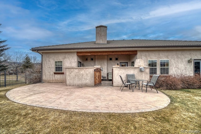 rear view of property with a yard and a patio area