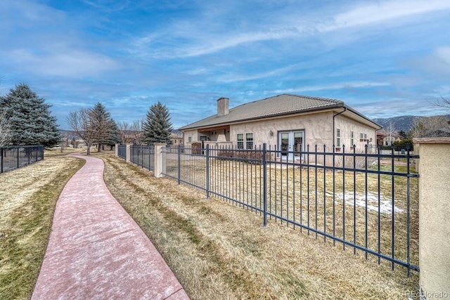 view of property exterior featuring french doors