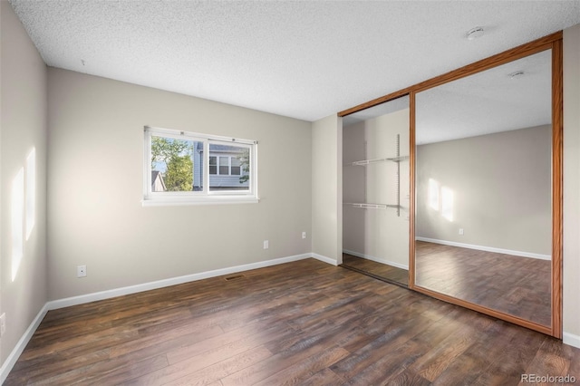 12665 Grove Ct, Broomfield, CO 80020 - unfurnished bedroom featuring wood finished floors, a closet, and a textured ceiling