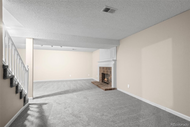 12665 Grove Ct, Broomfield, CO 80020 - unfurnished living room featuring carpet floors, a brick fireplace, a textured ceiling, and stairway