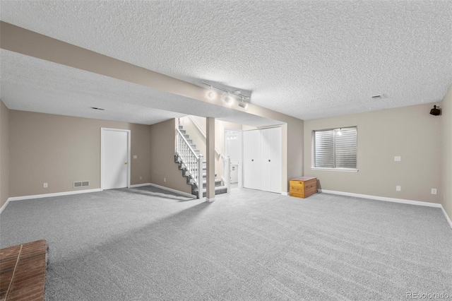 12665 Grove Ct, Broomfield, CO 80020 - below grade area with stairs, carpet floors, and a textured ceiling