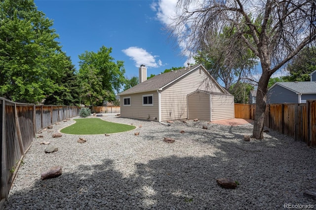 12665 Grove Ct, Broomfield, CO 80020 - rear view of house featuring a fenced backyard, a chimney, and a patio area