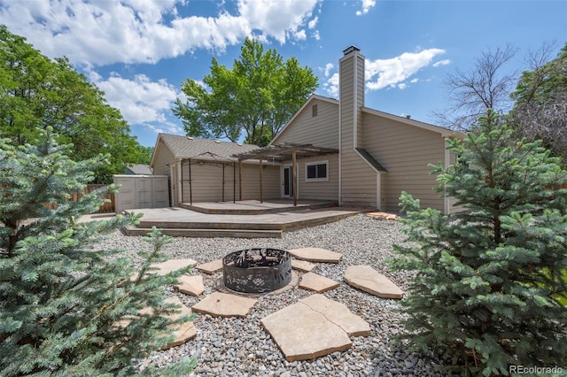 12665 Grove Ct, Broomfield, CO 80020 - rear view of property featuring a fire pit, a pergola, a storage unit, a patio, and a chimney