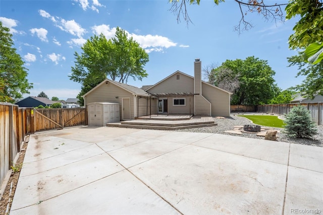 12665 Grove Ct, Broomfield, CO 80020 - back of property featuring a deck, a fenced backyard, a fire pit, a patio, and a chimney