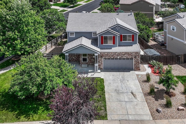 2452 S Andes Cir, Aurora, CO 80013 - view of front of house with stone siding, concrete driveway, and an attached garage