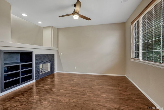 2452 S Andes Cir, Aurora, CO 80013 - unfurnished living room with a ceiling fan, wood finished floors, a stone fireplace, and recessed lighting