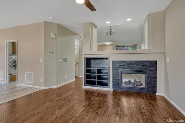 2452 S Andes Cir, Aurora, CO 80013 - unfurnished living room with washer / clothes dryer, a ceiling fan, wood finished floors, a stone fireplace, and recessed lighting