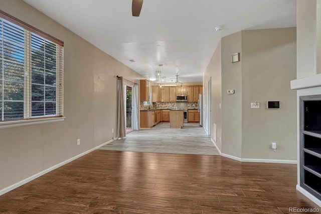 2452 S Andes Cir, Aurora, CO 80013 - unfurnished living room with light wood-style floors and ceiling fan