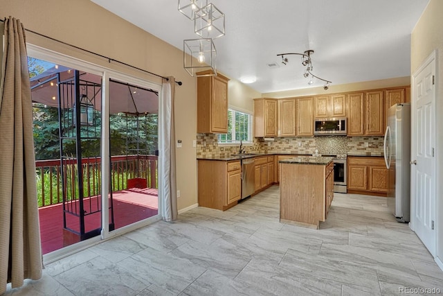 2452 S Andes Cir, Aurora, CO 80013 - kitchen featuring appliances with stainless steel finishes, light marble finish flooring, a center island, backsplash, and pendant lighting