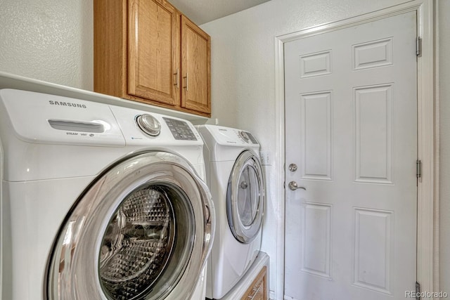 2452 S Andes Cir, Aurora, CO 80013 - washroom featuring cabinet space, separate washer and dryer, and a textured wall