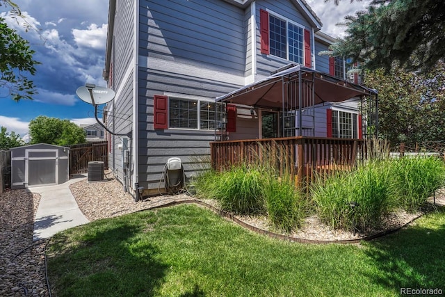 2452 S Andes Cir, Aurora, CO 80013 - back of property with a storage shed, a deck, and a lawn