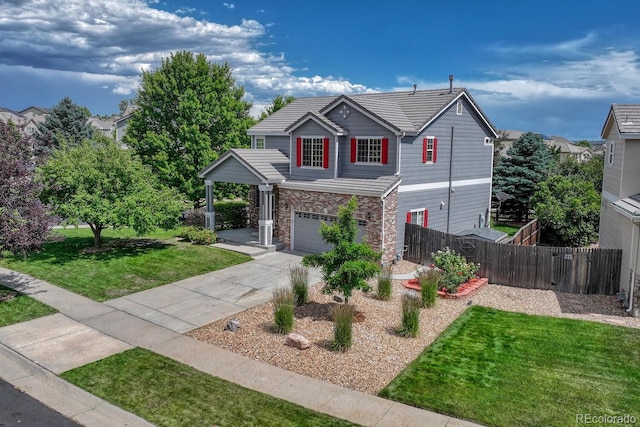 2452 S Andes Cir, Aurora, CO 80013 - traditional-style home with an attached garage, driveway, and stone siding