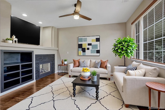 2452 S Andes Cir, Aurora, CO 80013 - living room with a ceiling fan, wood finished floors, recessed lighting, and a stone fireplace