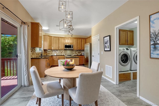 2452 S Andes Cir, Aurora, CO 80013 - dining area featuring separate washer and dryer and light marble finish flooring
