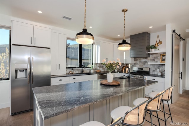 103 Paintbrush Way, Glenwood Springs, CO 81601 - kitchen with appliances with stainless steel finishes, light wood finished floors, backsplash, white cabinets, and open shelves