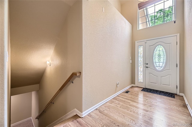 6727 W Yale Ave, Lakewood, CO 80227 - entrance foyer with healthy amount of natural light, light wood finished floors, baseboards, and a textured wall