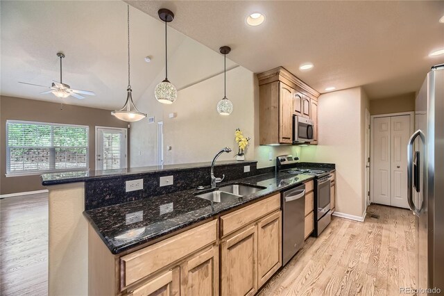 6727 W Yale Ave, Lakewood, CO 80227 - kitchen with a sink, appliances with stainless steel finishes, light wood finished floors, a peninsula, and a ceiling fan
