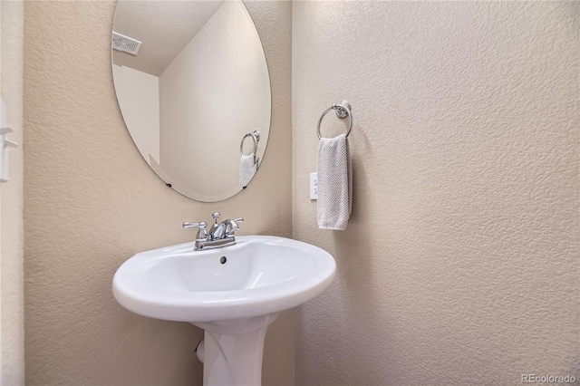 6727 W Yale Ave, Lakewood, CO 80227 - bathroom with a sink and a textured wall