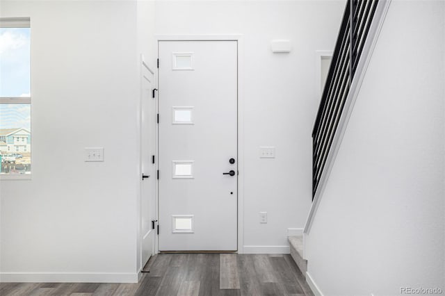 entryway featuring stairs, baseboards, and wood finished floors