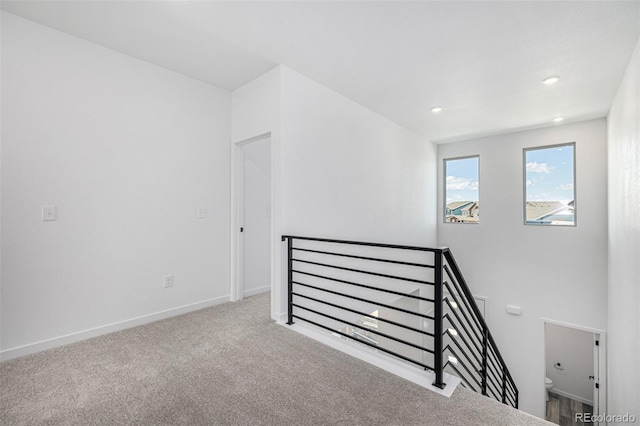 unfurnished room with recessed lighting, baseboards, and carpet floors