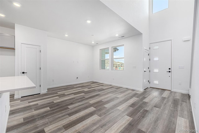 interior space with baseboards, recessed lighting, visible vents, and light wood-type flooring