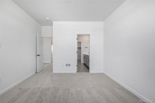 unfurnished bedroom with baseboards, visible vents, and carpet