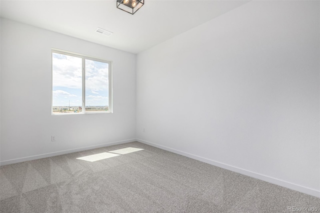 empty room featuring visible vents, baseboards, and carpet floors