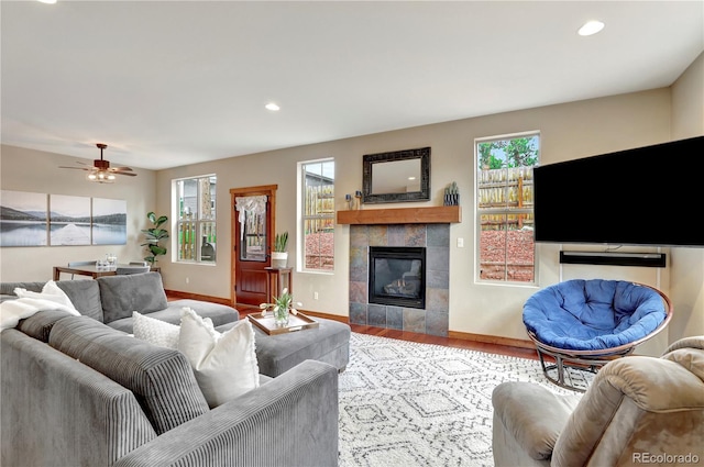 living area with recessed lighting, baseboards, wood finished floors, and a fireplace