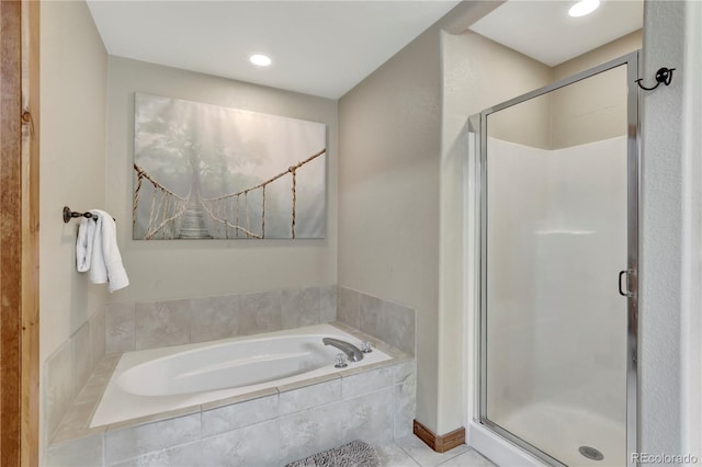 bathroom with tile patterned floors, a stall shower, and a bath