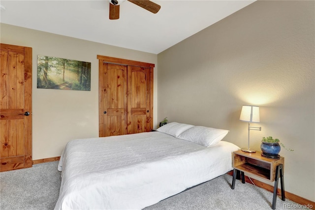 carpeted bedroom featuring a closet, ceiling fan, and baseboards