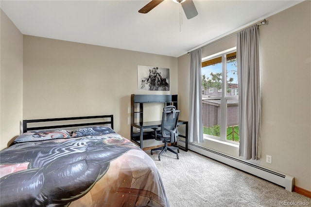 bedroom with a ceiling fan, multiple windows, carpet, and a baseboard radiator