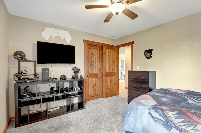 carpeted bedroom featuring a closet and ceiling fan