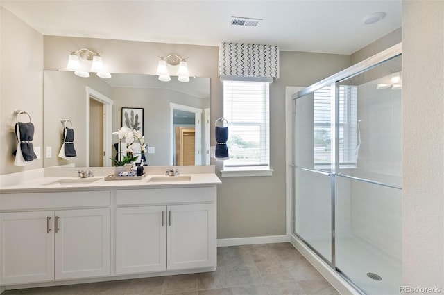 bathroom with vanity and a shower with door